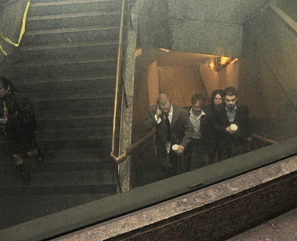 The four members of the band Lip Critic walking up the stairs