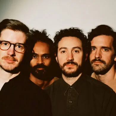 The four members of Darlingside close up looking into the camera.