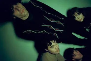 The four members of the band slate