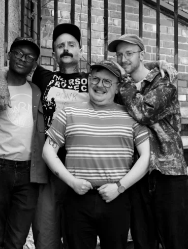 Black and white photo of the four members of the band Thank